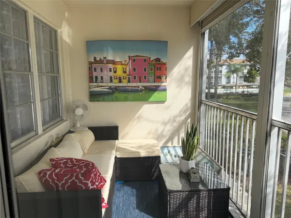 a living room with furniture and a floor to ceiling window