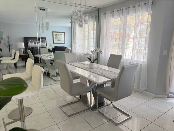 a view of a dining room with furniture and a window