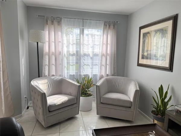 a living room with furniture and a potted plant