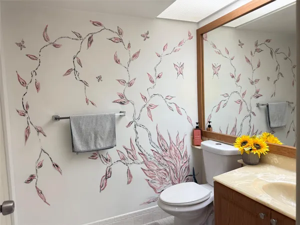 a white toilet sitting next to a shower curtain