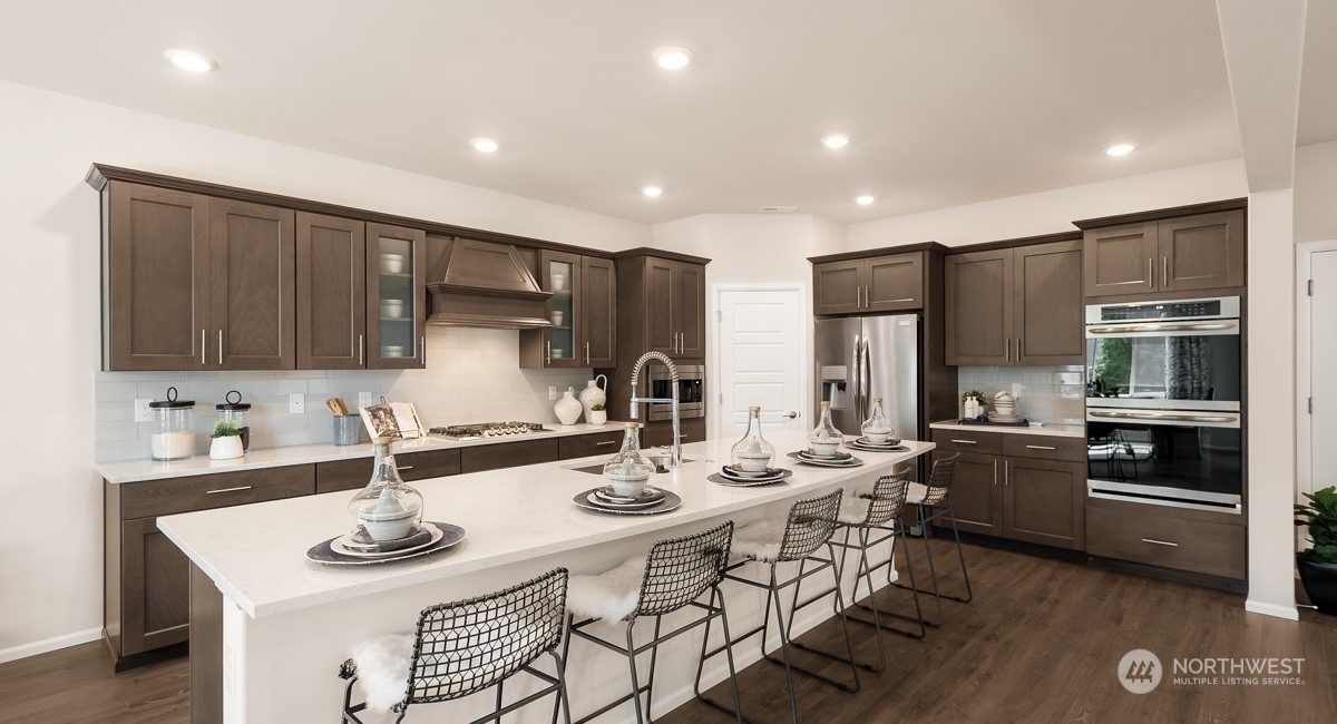 4130 235th Place Southeast, Unit 44 Bothell, WA 98021 - Photo 7 of 19 a kitchen with stainless steel appliances kitchen island granite countertop a sink and cabinets