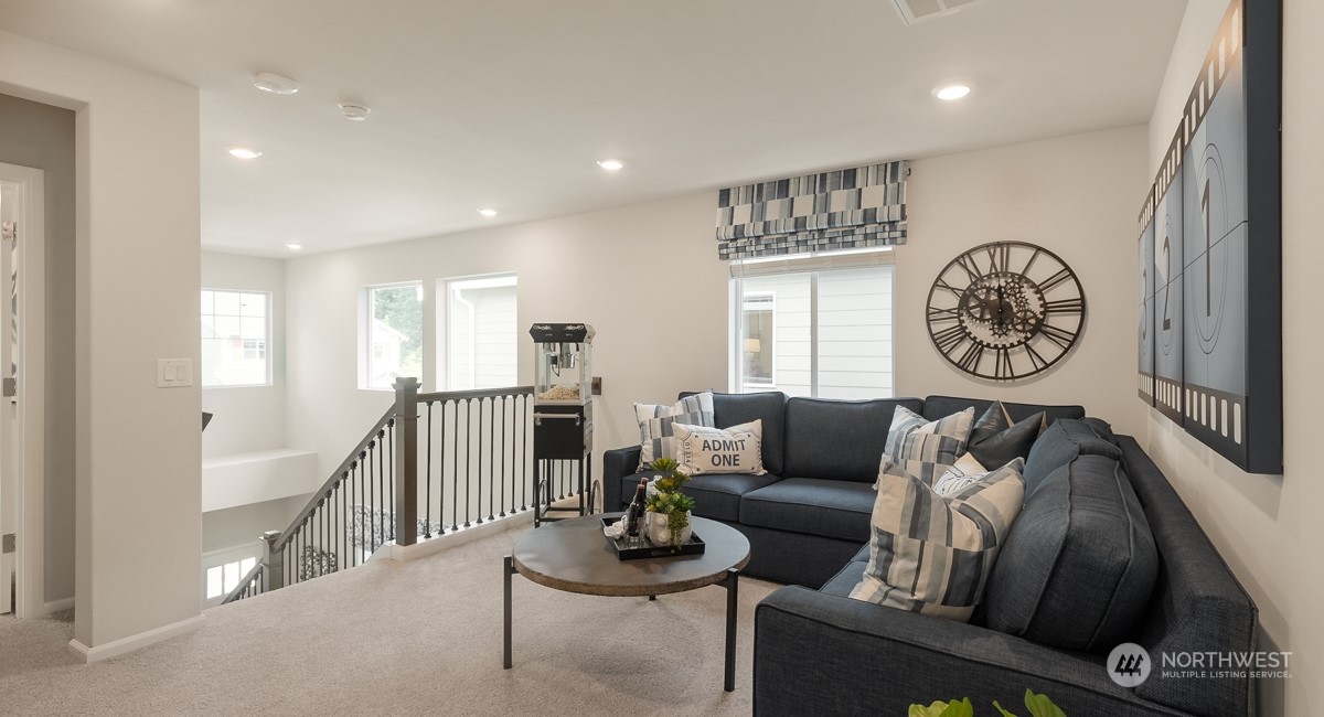 4130 235th Place Southeast, Unit 44 Bothell, WA 98021 - Photo 10 of 19 a living room with furniture and a clock