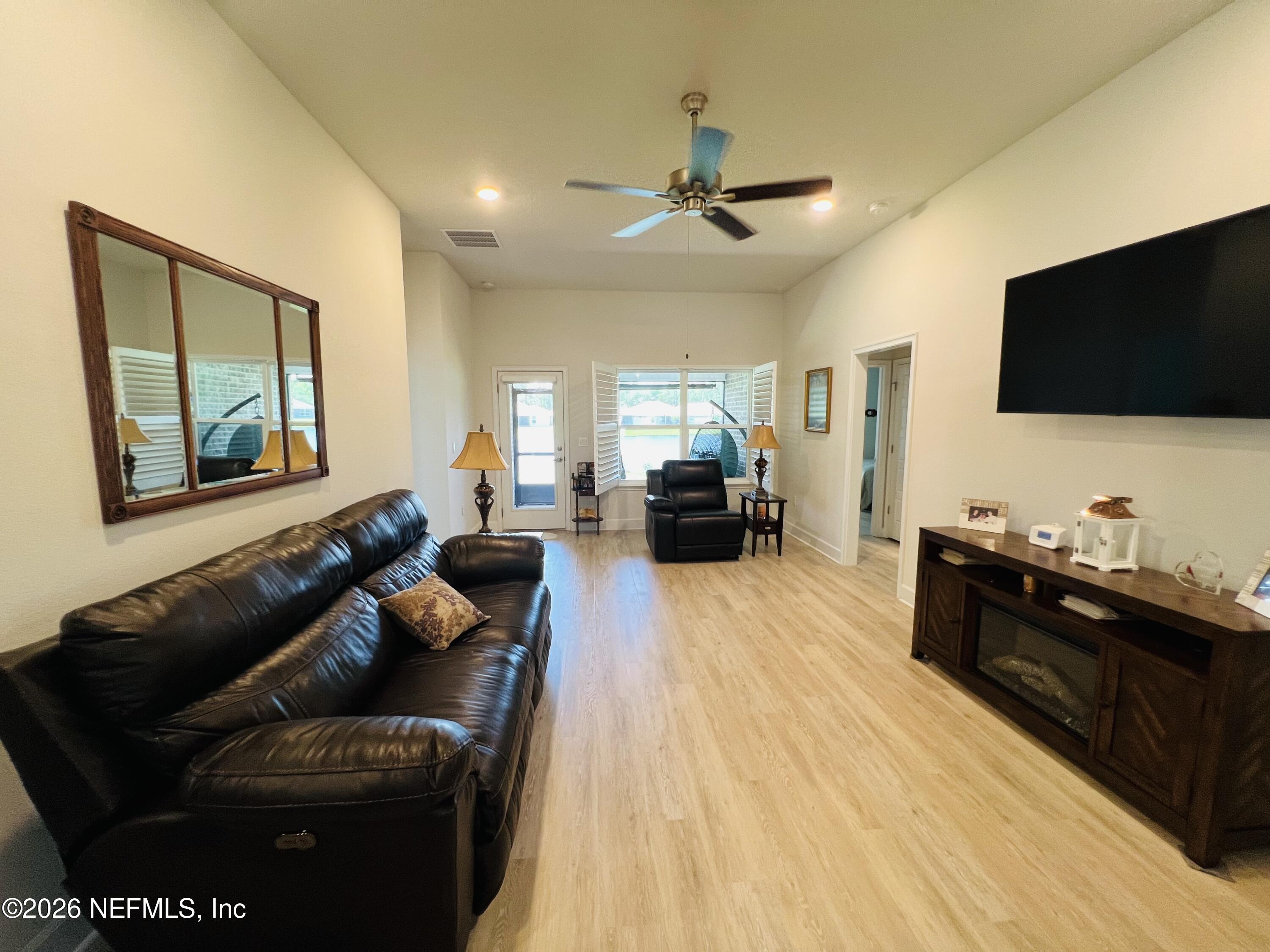 2 Rivertown Road Palm Coast, FL 32137 - Photo 51 of 80 a living room with furniture and a flat screen tv