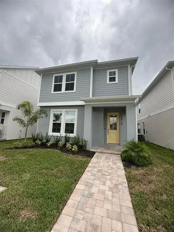 a front view of a house with a garden and plants