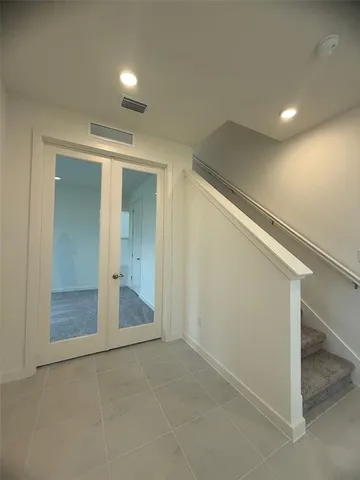 wooden floor in an empty room with a bathroom