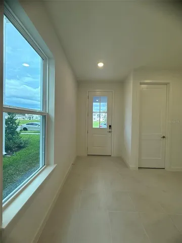 a view of an empty room and a window