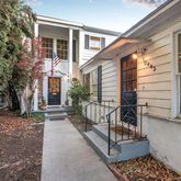 a view of house with a large window and wooden fence