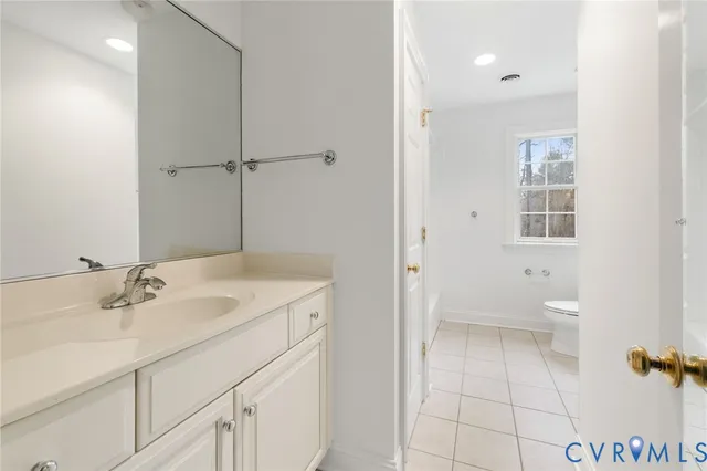 a bathroom with a sink toilet and vanity