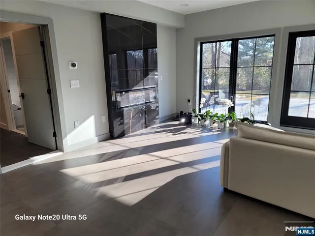 a living room with furniture a flat screen tv and a window