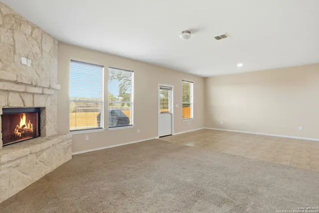 a view of a hallway with entryway and wooden floor