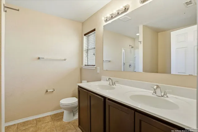 a view of a bathroom with a shower and a sink