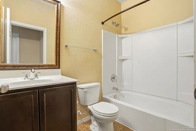 an empty room with chandelier fan