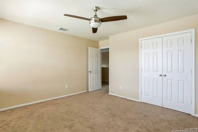 a view of a house with backyard and trees