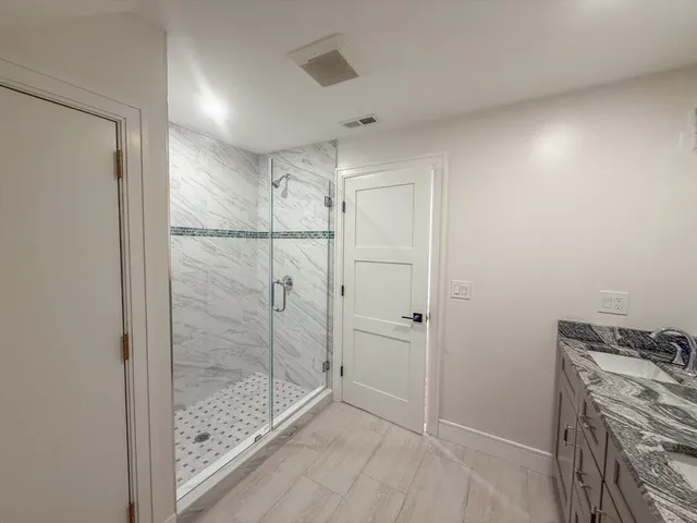 a bathroom with a shower and closet