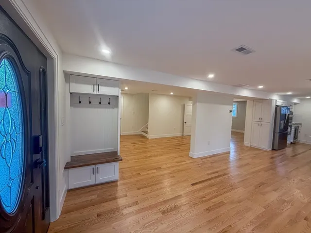 a view of empty room with wooden floor