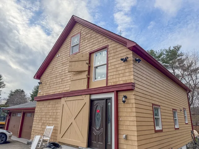 a view of small house with roof and stairs