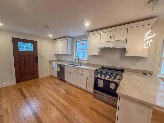 a kitchen with a stove a sink and a refrigerator