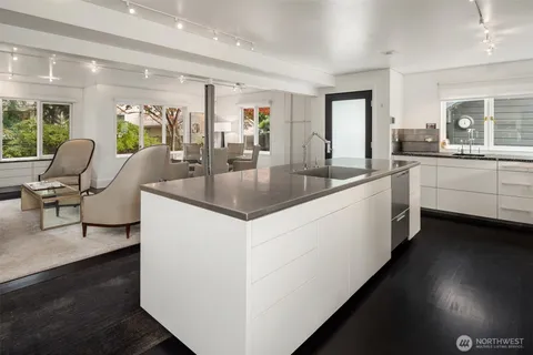 a kitchen with center island table and chairs