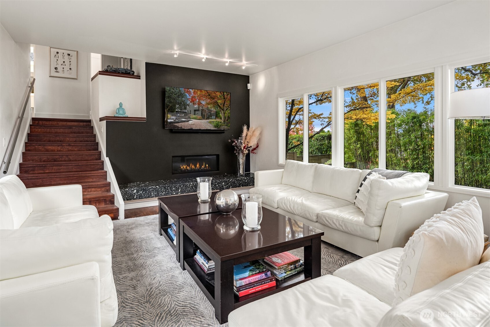 1615 39th Avenue East Seattle, WA 98112 - Photo 13 of 37 a living room with furniture a flat screen tv and a floor to ceiling window