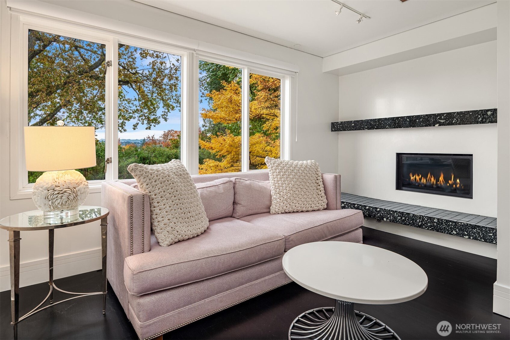 1615 39th Avenue East Seattle, WA 98112 - Photo 15 of 37 a living room with furniture a fireplace and a large window