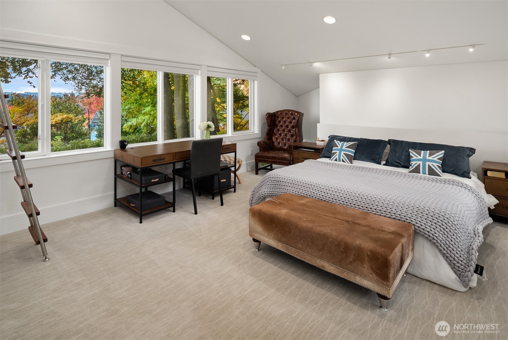 1615 39th Avenue East Seattle, WA 98112 - Photo 16 of 37 a spacious bedroom with a bed and a table