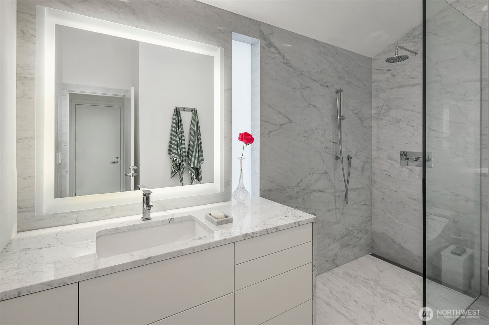 1615 39th Avenue East Seattle, WA 98112 - Photo 23 of 37 a bathroom with a shower sink and mirror