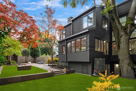 a view of a house with backyard and sitting area