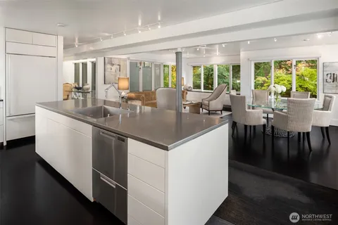 a kitchen with center island table and chairs