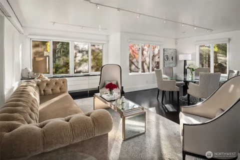 a living room with furniture and floor to ceiling windows