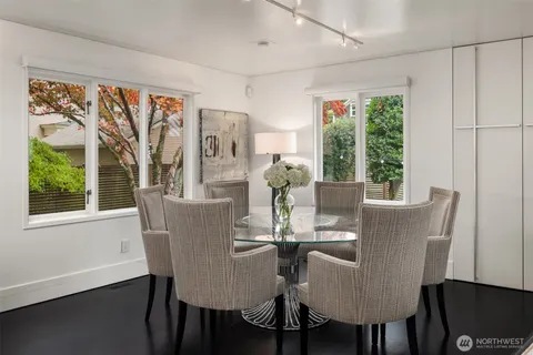 a dining room with furniture a window and a chandelier