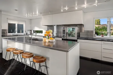 a kitchen with stainless steel appliances a sink and a large window