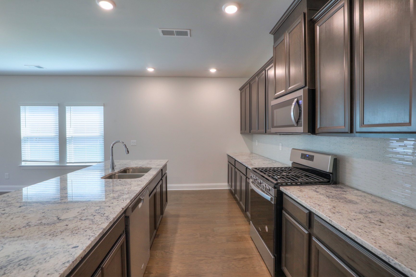 3546 Four Leaf Way Antioch, TN 37013 - Photo 11 of 35 a kitchen with stainless steel appliances granite countertop a sink stove and cabinets