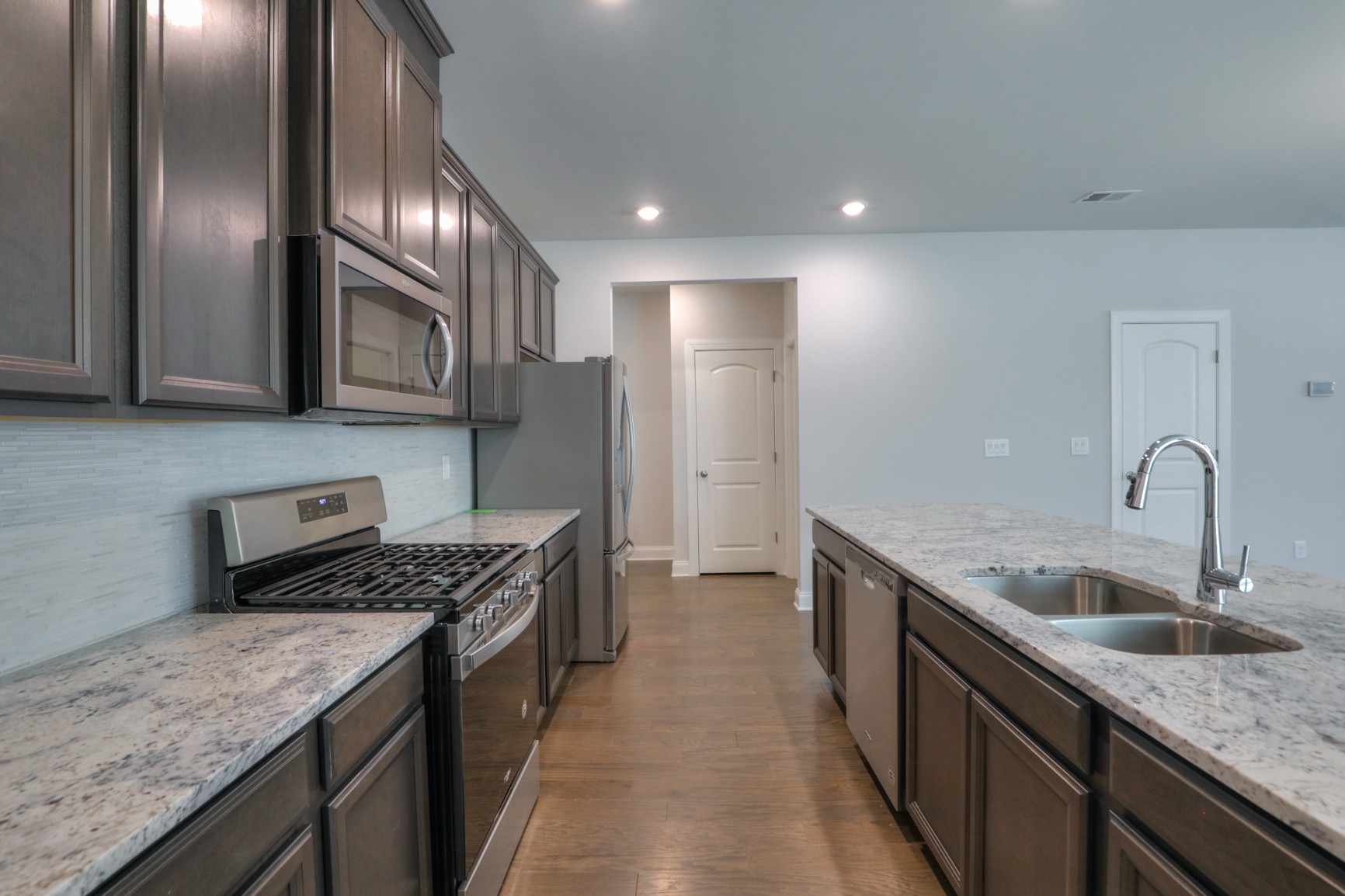 3546 Four Leaf Way Antioch, TN 37013 - Photo 13 of 35 a kitchen with stainless steel appliances granite countertop a sink a stove and a refrigerator