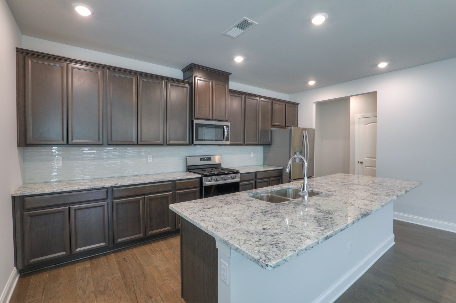 3546 Four Leaf Way Antioch, TN 37013 - Photo 9 of 35 a kitchen with kitchen island granite countertop a sink stove and cabinets