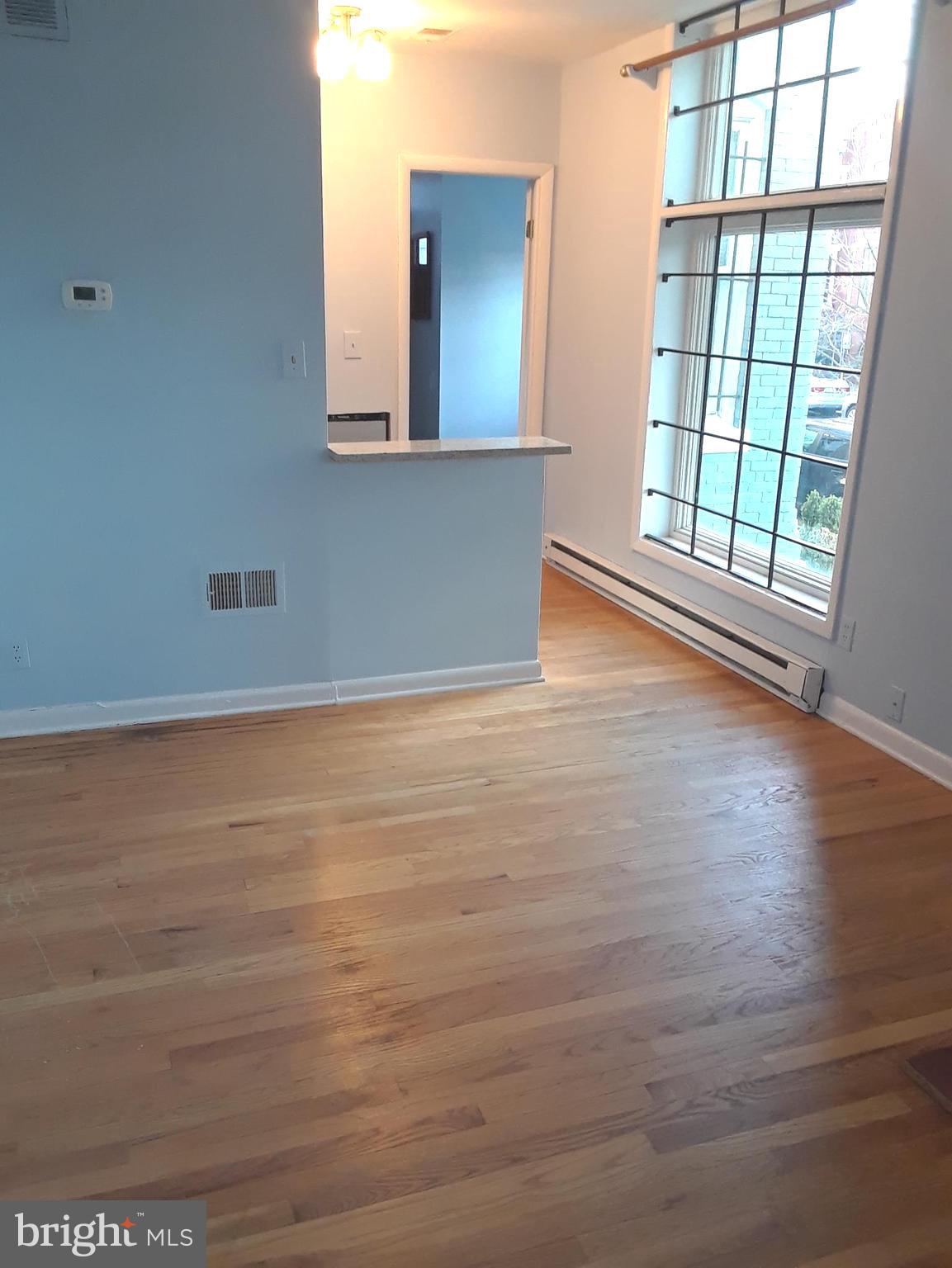401 E Street Northeast, Unit 1 Washington, DC 20002 - Photo 3 of 5 a view of an empty room with wooden floor and a window