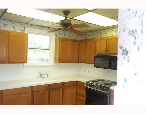 a kitchen with a stove a sink and a microwave
