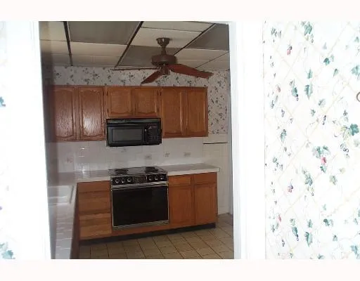 a kitchen with stainless steel appliances granite countertop a stove and a microwave