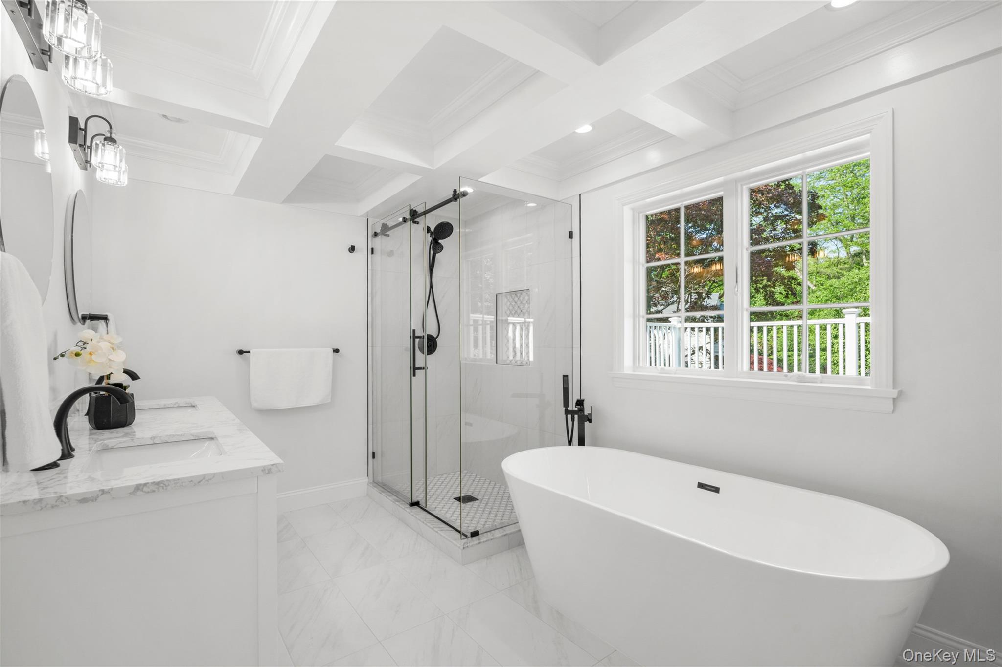63 Rye Road Rye, NY 10580 - Photo 22 of 50 Newly renovated primary bath with soaking tub, glass-enclosed shower and treetop views.