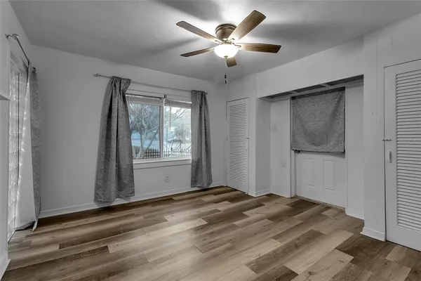 a view of a livingroom with a ceiling fan and window