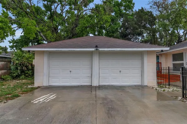 a view of a house with a small yard and plants