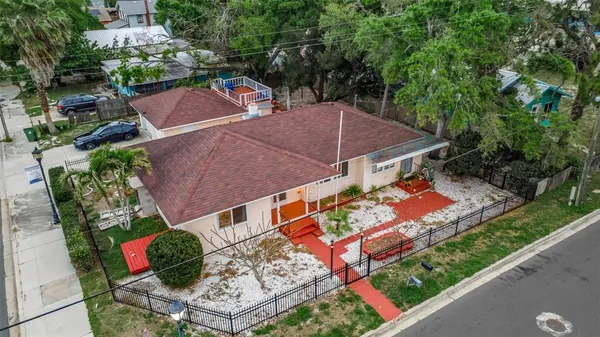 an aerial view of multiple houses with a yard