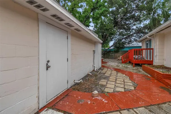 a view of a backyard with plants and tree