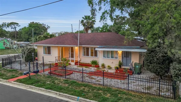 a view of house with a yard and sitting area