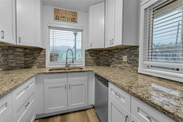 a kitchen with sink cabinets and window