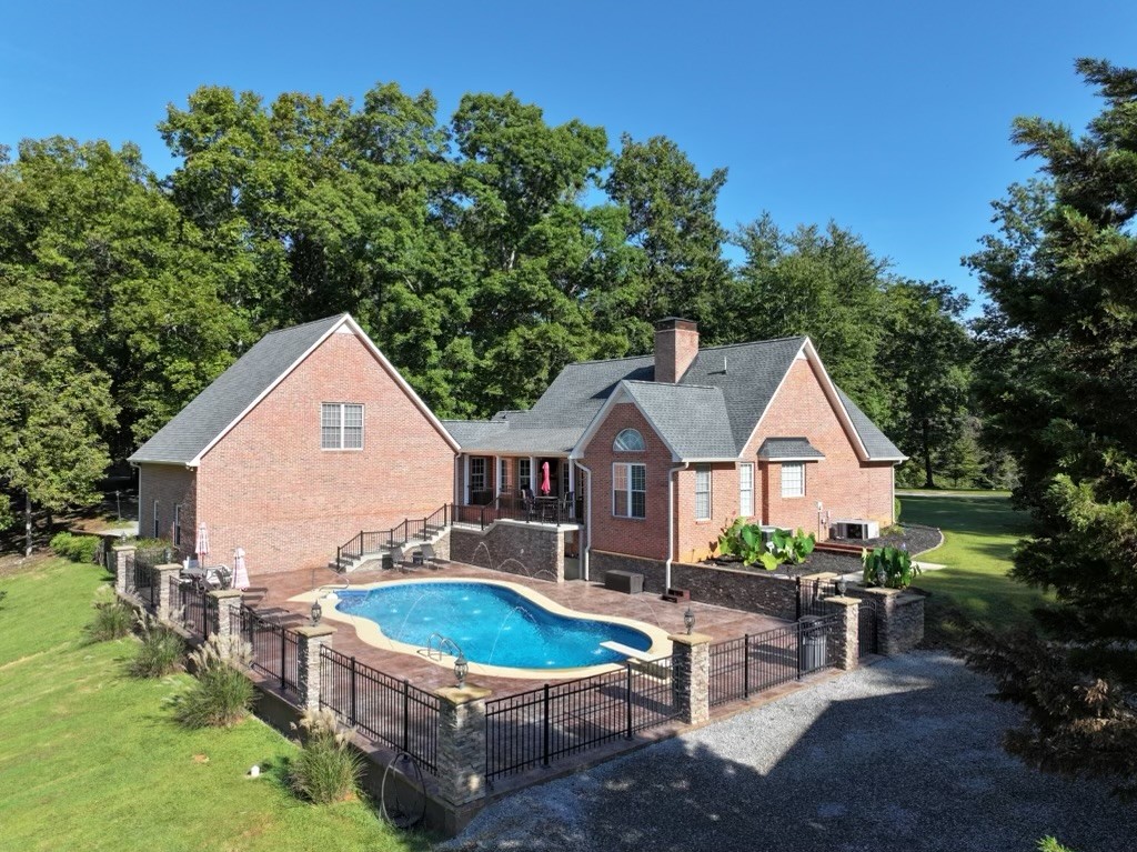 844 Ed Sanders Road Lynchburg, TN 37352 - Photo 2 of 46 a view of a house with pool and chairs