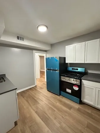 a kitchen with refrigerator and window