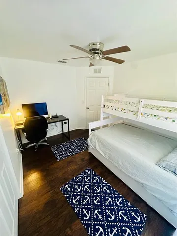 a bedroom with a bed and a chair