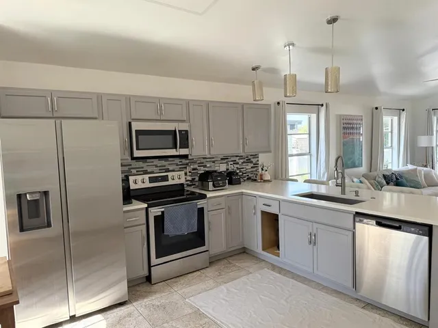 a kitchen with a sink stove and refrigerator