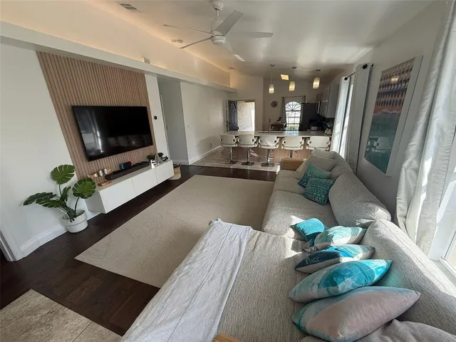 a living room with furniture potted plant a flat screen tv and a fireplace