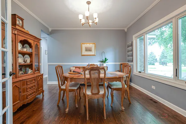 a view of a dining room with furniture window and wooden floor